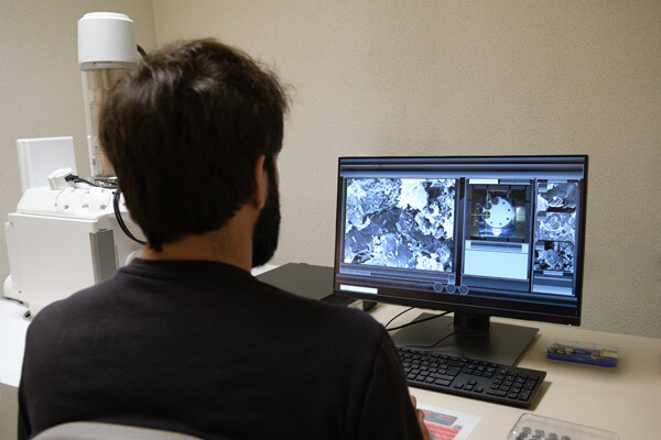 Scientist at scanning electron microscope